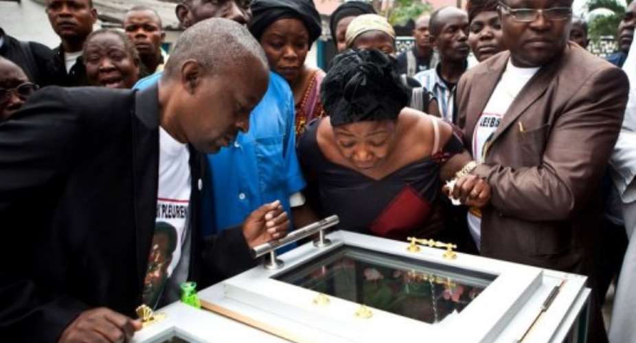 The family and friends of Floribert Chebeya view his body in Kinshasa in 2010.  By Gwenn Dubourthoumieu (AFP/File)