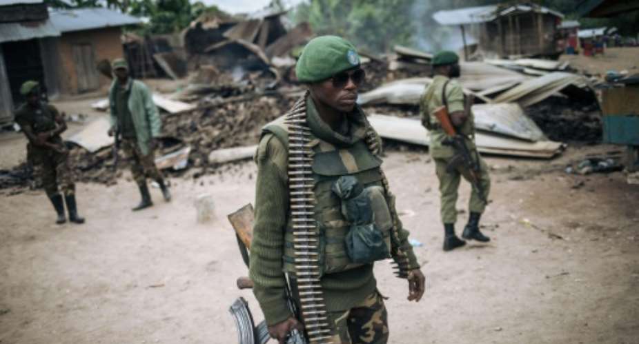 DR Congo's armed forces are struggling to cope with a surge of attacks by the ADF militia. Here, troops patrol the village of Manzalaho after a raid in February last year.  By Alexis Huguet AFPFile