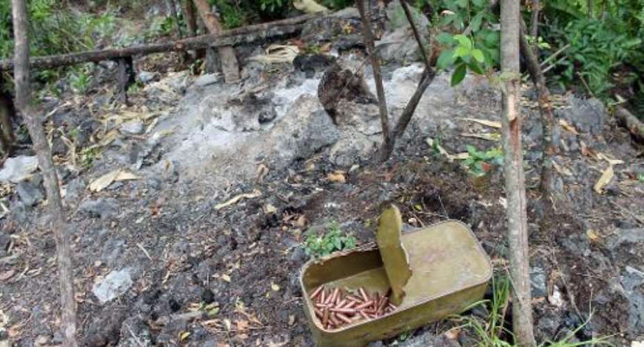 A box of ammunition, reportedly abandoned by Rwandan ethnic Hutu rebels of the FDLR, sits on the ground near Tongo, Democratic Republic of Congo, on March 11, 2014.  By Alain Wandimoyi AFPFile