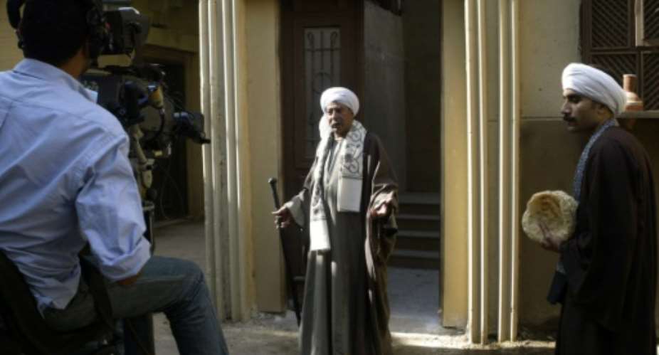 During filming in 2006 at Cairo's Al-Ahram Studio, Salah al-Saadani performs in the Ramadan TV series 'Haret al-Zaafarani'.  By AMRO MARAGHI AFPFile