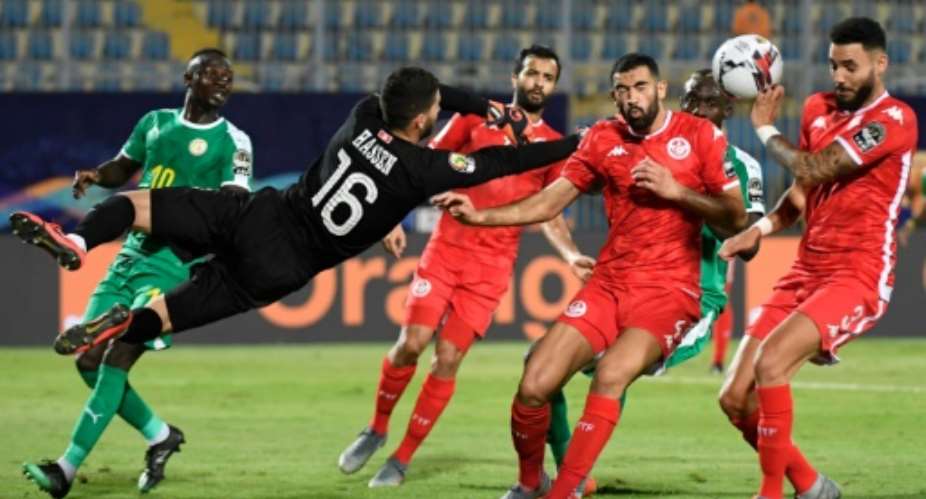Dylan Bronn R of Tunisia concedes the own goal that gave Senegal victory in an Africa Cup of Nations semi-final in Cairo.  By Khaled DESOUKI AFP