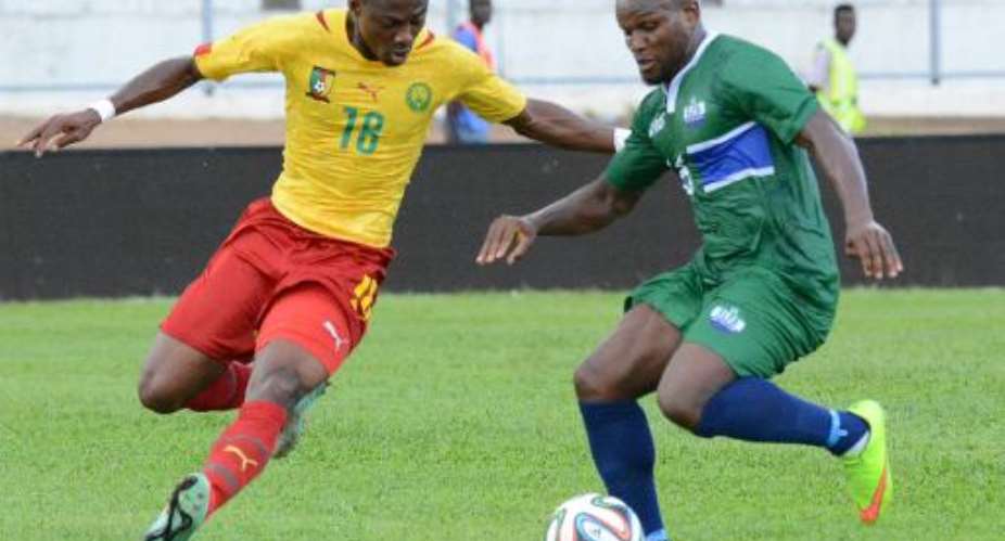 Cameroon's midfielder Eyong Enoh L vies for the ball with Sierra Leone's midfielder Julius Wobay during the 2015 African Cup of Nations qualifying football match on October 11, 2014 in Yaounde.  By Pacome Pabandji AFPFile