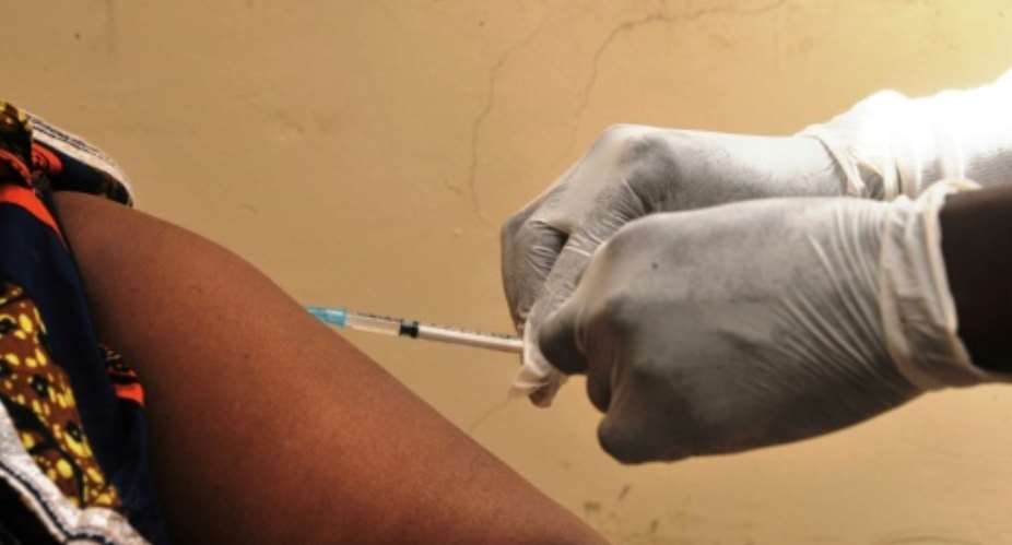 A woman gets vaccinated on March 10, 2015 at a health center in Conakry during the first clinical trials of the VSV-EBOV vaccine against the Ebola virus.  By Cellou Binani AFPFile