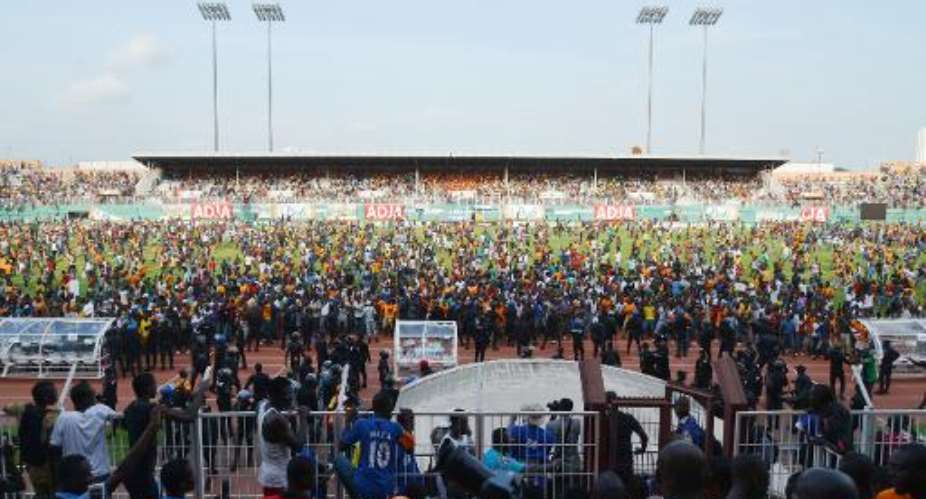 Supporters invade the pitch at the Felix Houphouet-Boigny Stadium in Abidjan on November 19, 2014 at the end of the 2015 Africa Cup of Nations group D qualifying football match between Ivory Coast and Cameroon.  By Issouf Sanogo AFP