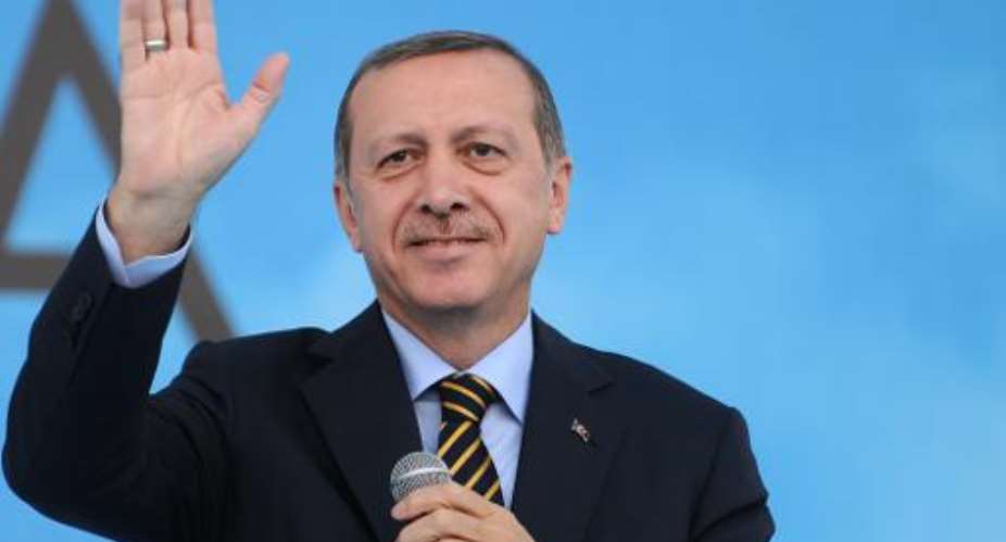 Recep Tayyip Erdogan gestures to the audience at a ceremony in Istanbul on July 25, 2014.  By Ozan Kose AFP