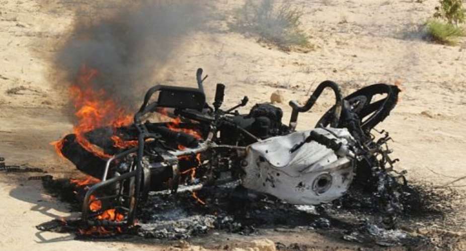 A motorbike burns after an earlier Egypt raid on the area. The military claims 23 have been arrested.  By Stringer AFPFile
