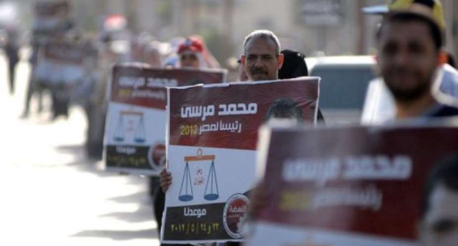 Egyptian supporters of Muslim Brotherhoods candidate for the presidential elections Mohammed Mursi.  By  (AFP)