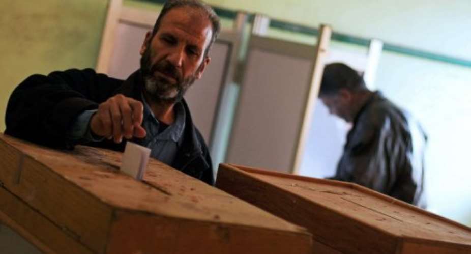 An Egyptian man casts his ballot at a polling station in Qaliubia during the final round of parliamentary elections.  By Mohammed Hossam (AFP/File)