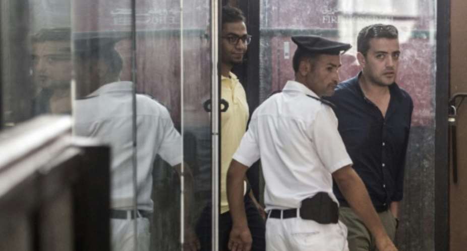 Al-Jazeera journalist Egyptian Baher Mohamed R attends his trial at the Torah prison in Cairo on August 2, 2015.  By Khaled Desouki AFPFile
