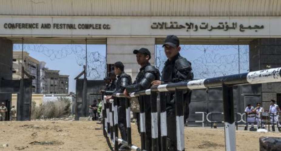Egyptian security forces stand guard outside the police academy during the trial of deposed Islamist president Mohamed Morsi on May 16, 2015 in Cairo.  By Khaled Desouki AFP