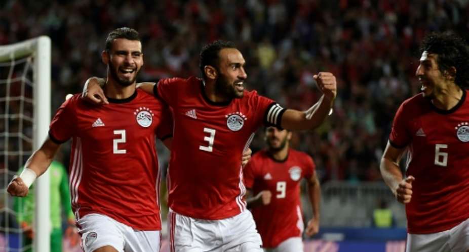 Egypt defenders Baher El-Mohamady L celebrates with his Ahmed Elmohamady C and Ahmed Hegazi R after scoring a goal during the Africa Cup of Nations qualifier football match against Tunisia near Alexandria November 16, 2018.  By KHALED DESOUKI AFPFile