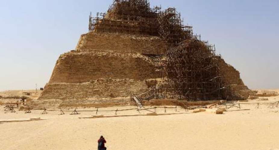 Tourist takes a picture of the step pyramid of Djoser on September 16, 2014.  By Mohamed el-Shahed AFP