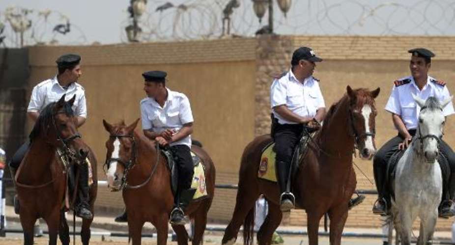 Egyptian mounted security stand guard outside the police academy in Cairo on April 21, 2015.  By Mohamed el-Shahed AFPFile