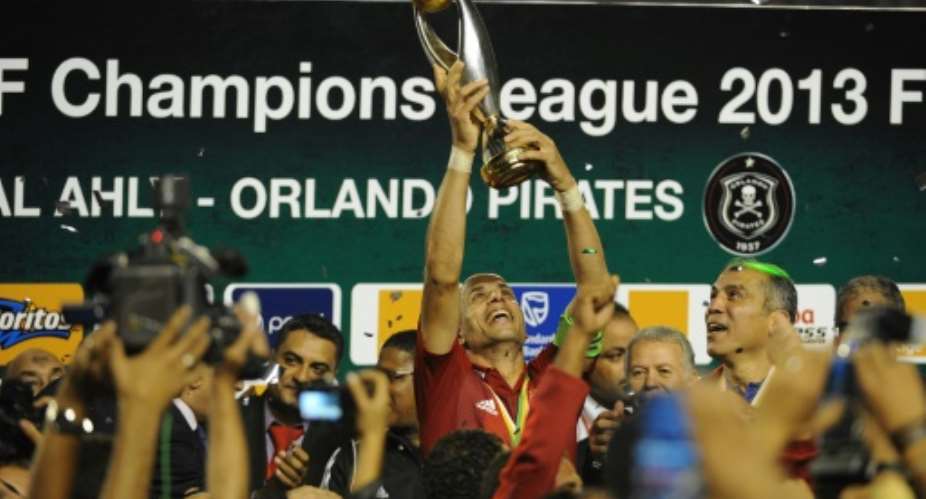 Egypt legend Wael Gomaa lifts the CAF Champions League trophy after Al Ahly won the 2013 final.  By GIANLUIGI GUERCIA AFP