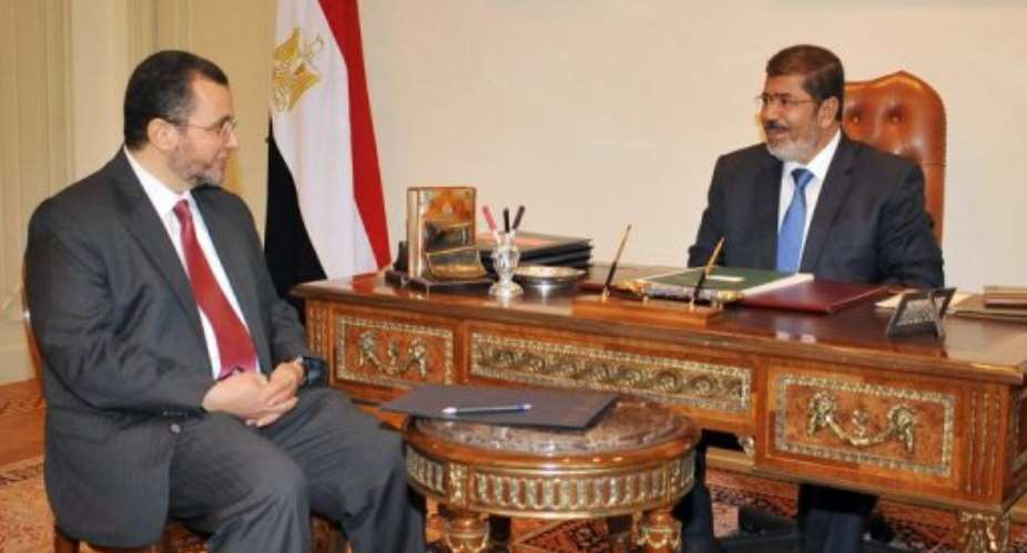 Egyptian President  Mohamed Morsi right meets with newly appointed Prime Minister Hisham Qandil in Cairo on July 24.  By  AFPEgyptian PresidencyFile