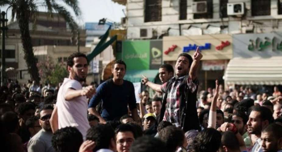 Egyptian anti-military protesters chant slogans during a demonstration outside the Egyptian Supreme Court.  By Gianluigi Guercia (AFP/File)
