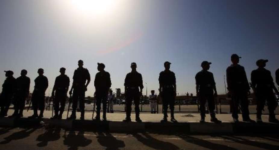 Egyptian police stand guard outside the police academy in Cairo on September 27, 2014.  By Mohamed el-Shahed AFP