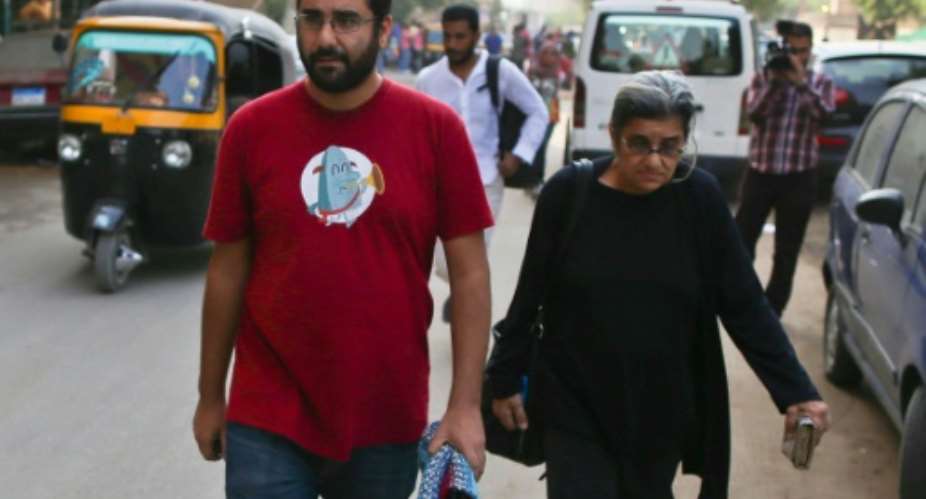 Egyptian activist Alaa Abdel Fattah left, who along with his sister is back in detention, walks with his mother Leila after a 2014 court hearing in Cairo.  By Mohamed el-Shahed AFPFile