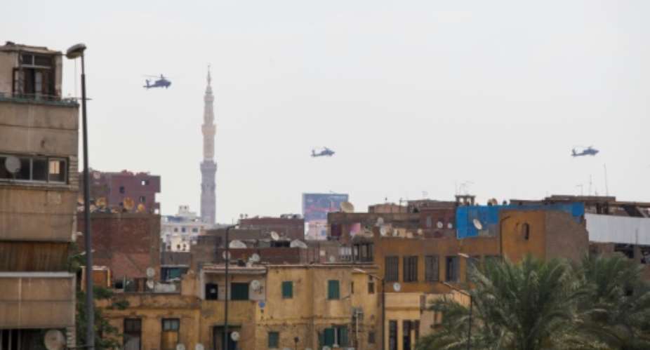 Egyptian air force Apache attack helicopters fly over Cairo on June 2, 2018, as Egyptian President Abdel-Fattah al-Sisi is sworn in for a second four-year term.  By STRINGER AFPFile