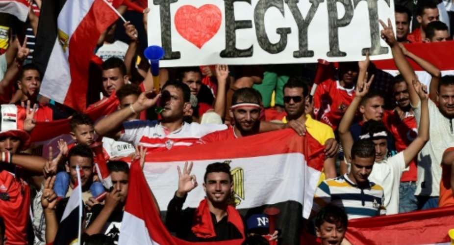 Egyptian fans cheer for their national team before the FIFA World Cup 2018 qualification football match against Uganda at the Borg al-Arab Stadium near Alexandria September 5, 2017.  By KHALED DESOUKI AFP