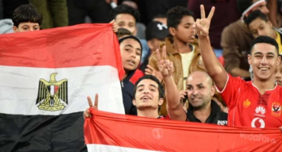 Egyptian fans cheer for their team ahead on an Africa Cup of Nations qualifier football match against Tunisia at the Borg El Arab Stadium near Alexandria on November 16, 2018.  By KHALED DESOUKI AFPFile
