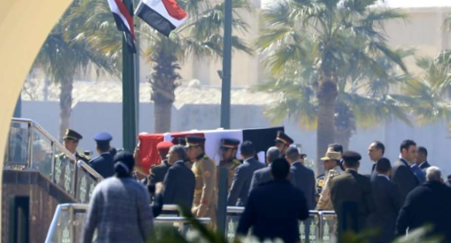 Egyptian honour guards carry the coffin of former president Hosni Mubarak before his funeral ceremony at Cairo's Mosheer Tantawy mosque in Cairo.  By Khaled DESOUKI AFP