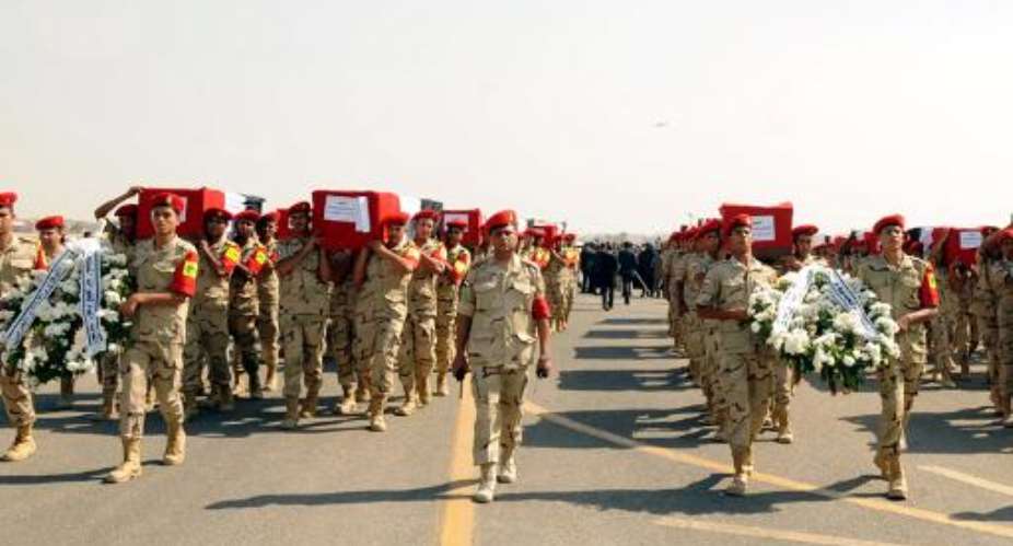 Picture released on October 25, 2014 by the Egyptian Presidency, shows the funeral for 30 solders killed in the Sinai in an attack claimed by the Ansar Beit al-Maqdis in a video posted on social media Friday.  By  Egyptian PresidencyAFPFile