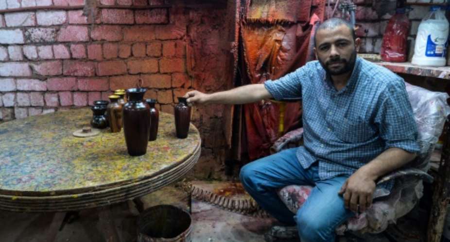 Egyptian potter Mostafa el-Agoury displays some of his pottery at his workshop in the village of Shamma, Menufiya province, on June 21, 2018.  By Mohamed el-Shahed AFP