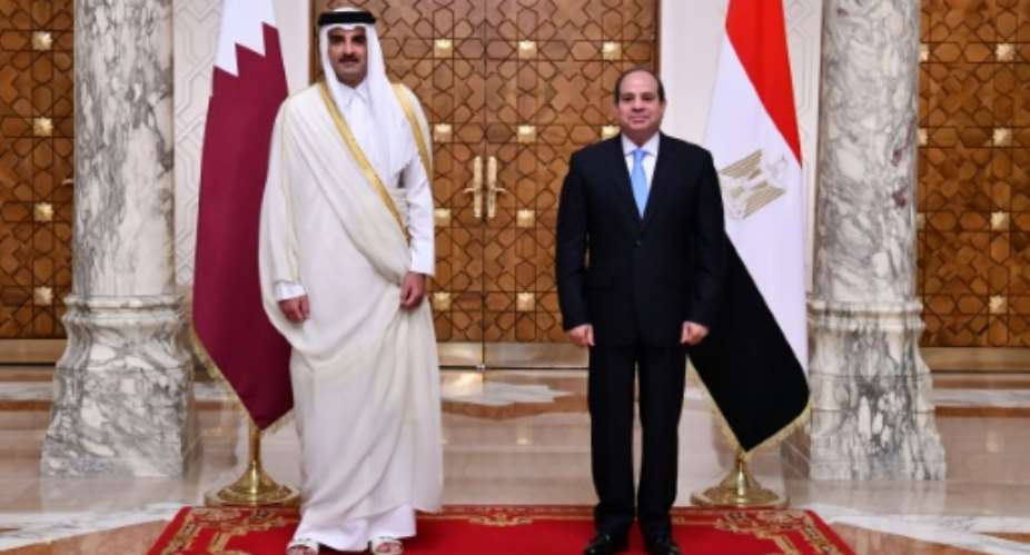 Egyptian President Abdel Fattah al-Sisi R receives the Emir of Qatar Sheikh Tamim bin Hamad Al-Thani at the presidential palace in the capital Cairo on June 25.  By Egyptian Presidency Egyptian PresidencyAFP