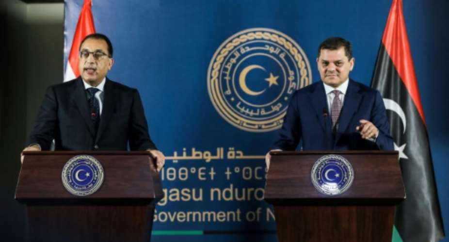 Egyptian Prime Minister Mostafa Madbouli, left, and interim Libyan Prime Miniser Abdulhamid Dbeibah hold a joint press conference in the capital Tripoli.  By Mahmud Turkia AFP