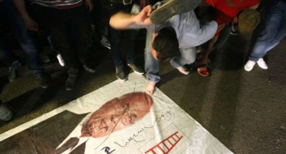 An Egyptian protester hits a portrait of presidential candidate and ex-prime minister Ahmed Shafiq in Cairo.  By Khaled Desouki AFP