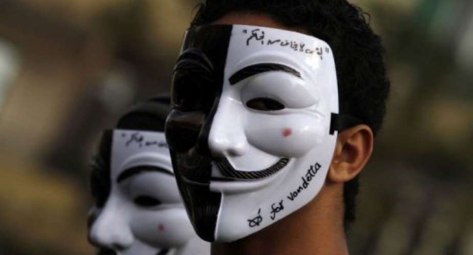 An Egyptian youth wears a mask during a demonstration in Cairo's Tahrir Square on January 31, 2013.  By Mohammed Abed AFP