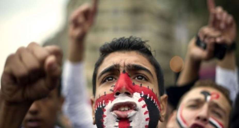 An Egyptian anti-military protester shouts slogans during a demonstration.  By Odd Andersen AFP