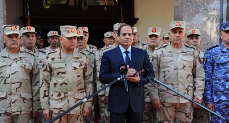 A picture released by the Middle East News Agency shows Egyptian President Abdel-Fattah el-Sisi C addressing journalists after an emergency meeting of the Supreme Council of the Armed Forces in Cairo on January 31, 2015.  By  MENAAFP