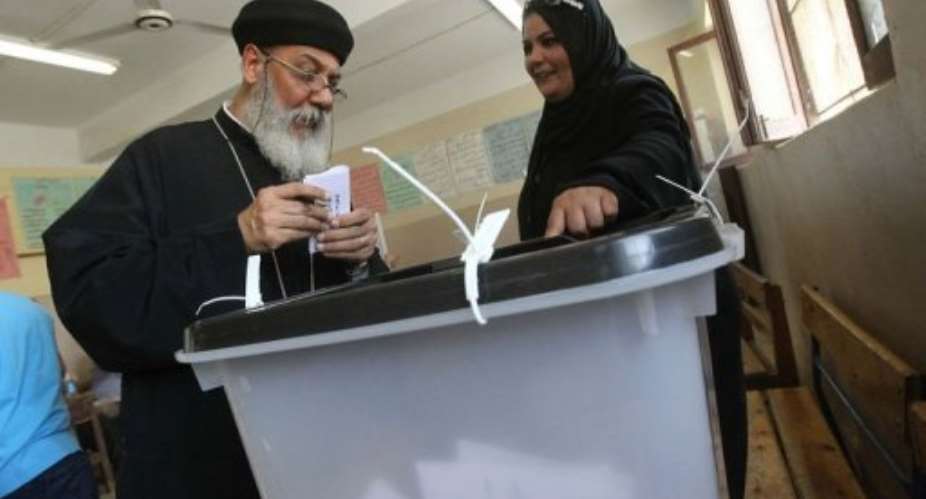 An Egyptian Coptic priest votes.  By Khaled Desouki (AFP)