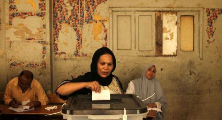 An Egyptian Christian Coptic woman casts her vote.  By Patrick Baz AFP
