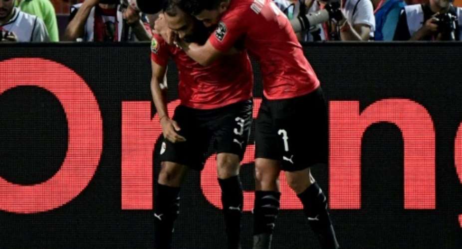 Egypt's defender Ahmed Elmohamady L and Mahmoud 'Trezeguet' Hassan starred as Egypt finished Group A with a perfect record.  By JAVIER SORIANO AFPFile