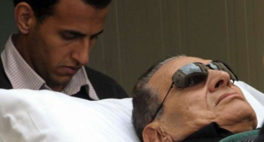 Ousted Egyptian President Hosni Mubarak is wheeled on a stretcher into court in January 2012.  By  (AFP/File)