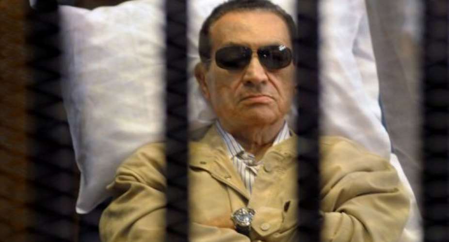 Ousted Egyptian president Hosni Mubarak sits inside a cage in a courtroom during his verdict hearing on June 2, 2012.  By  (AFP/File)