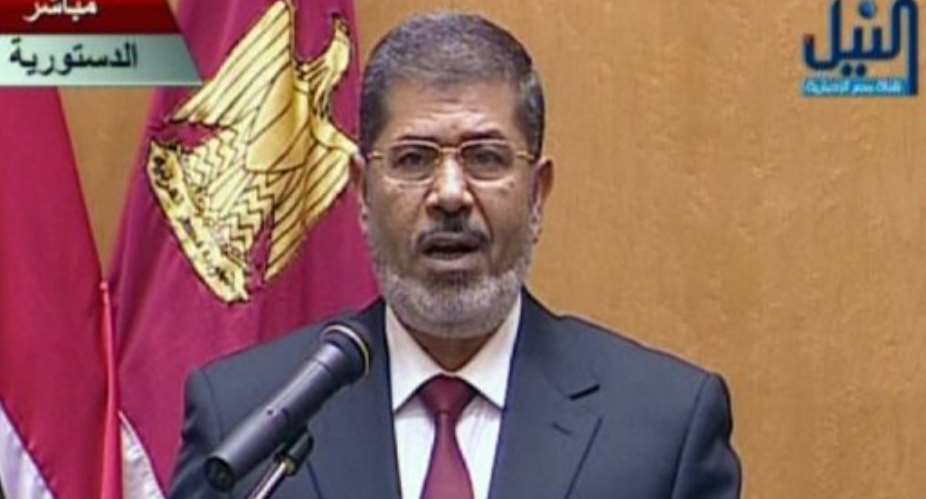 Mohamed Morsi wore a suit a burgundy tie for today's swearing in ceremony.  By  AFP