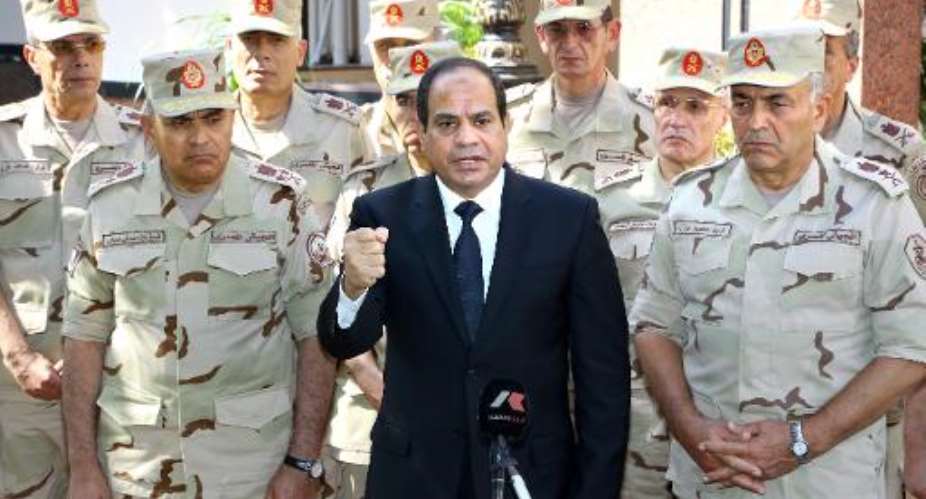 Egyptian President Abdel Fattah al-Sisi centre addresses journalists following an emergency meeting of the Supreme Council of the Armed Forces in Cairo, on October 25, 2014.  By  Egyptian PresidencyAFP