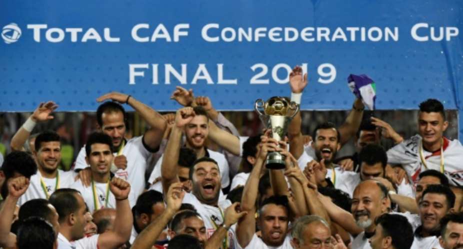 Egypt's Zamalek players celebrate with the trophy after they won the CAF Confederation Cup final on penalties against Morocco's RSB Berkane.  By Khaled DESOUKI AFP