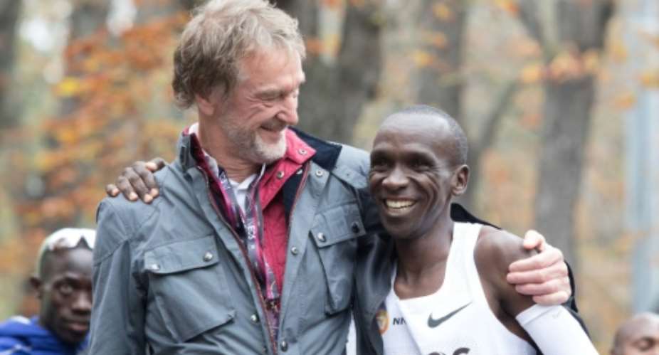 Eliud Kipchoge celebrates with Ineos owner Jim Ratcliffe after the Kenyan broke the two-hour marathon barrier in an event heavily sponsored by the petrochemicals company.  By ALEX HALADA AFPFile