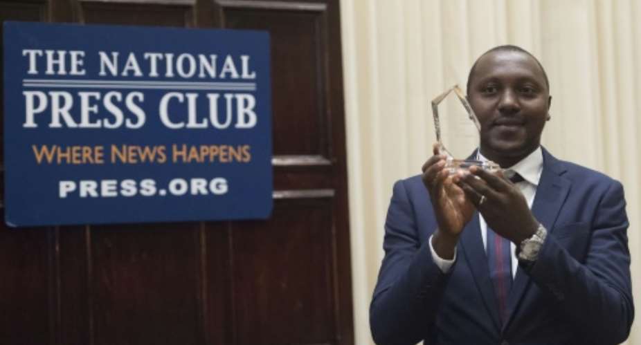 Eloge Willy Kaneza, reporter from SOS Media Burundi, receives the 2016 Peter Mackler Award during an awards ceremony at the National Press Club in Washington, DC, October 13, 2016.  By Saul loeb AFP