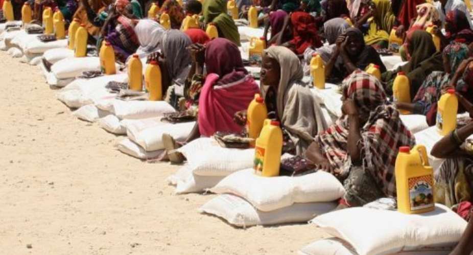 Internally displaced women receive food-aid at a distribution centre in Mogadishu.  By Abdurashid Abikar AFPFile