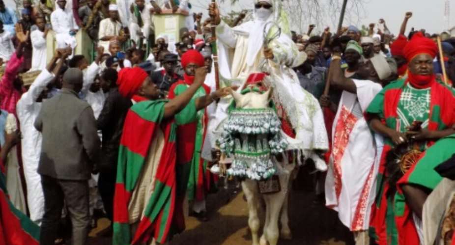 Emir of Kano Muhammadu Sanusi II (C), seen here before he was deposed four years ago. He has now been reinstated.  By AMINU ABUBAKAR (AFP)