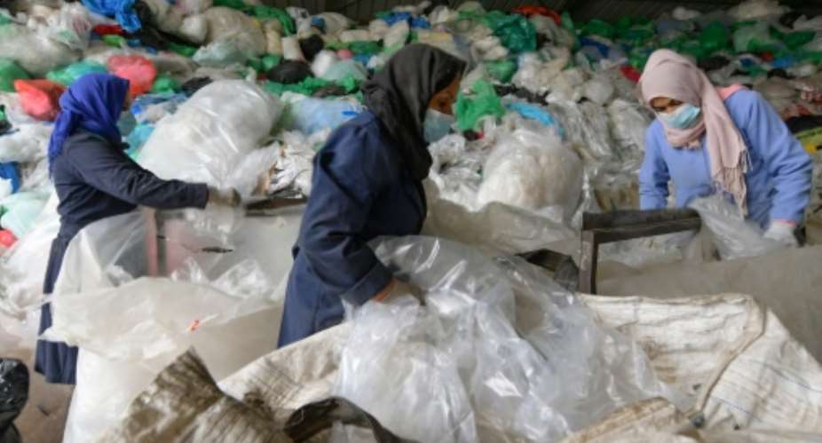 Employees sort through piles of plastic waste at African Recycling, one of the few recycling companies in Tunisia.  By FETHI BELAID AFP