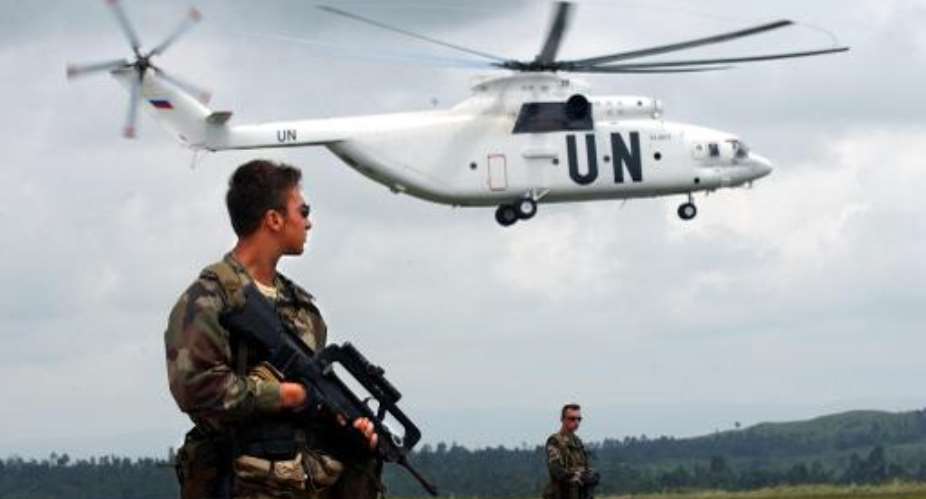 A UN French special forces soldier watches over the situation while a UN helicopter lands on June 10, 2003, on Bunia airport in the Democratic Republic of Congo.  By Eric Feferberg AFPFile