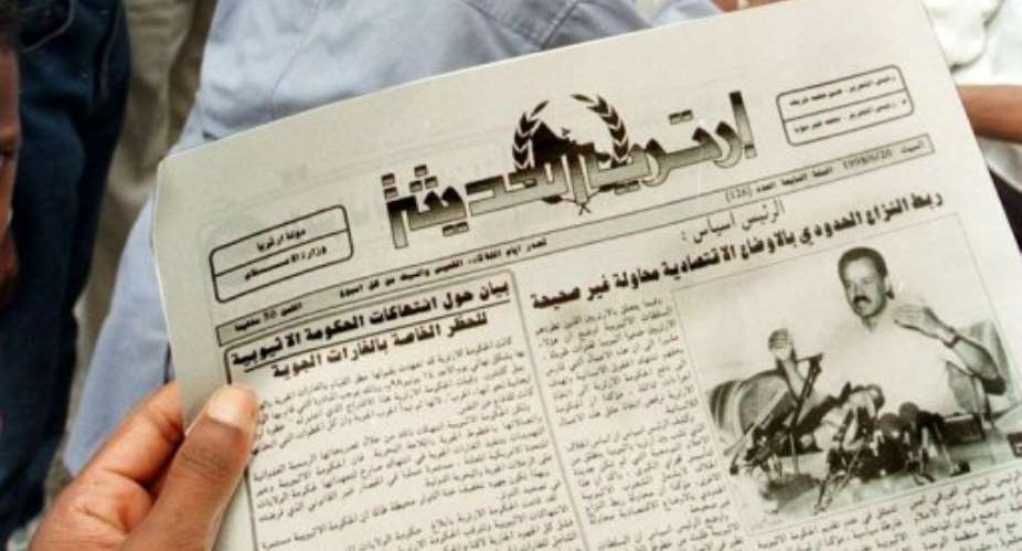 Eritreans buy newspapers in Asmara.  By AMR NABIL (AFP/File)