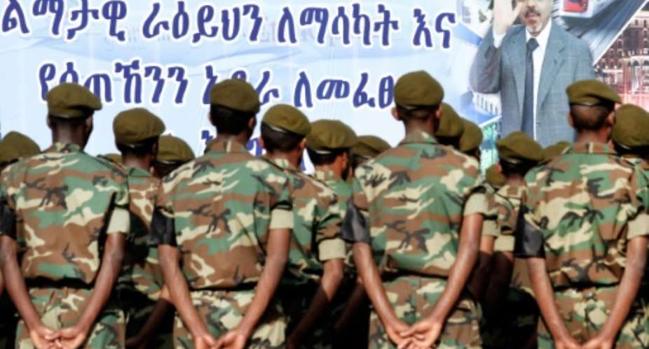 Ethiopian soldiers take part to the official state funeral of Ethiopia's late Prime Minister Meles Zenawi under a giant poster of late strongman in Addis Ababa on September 2, 2012.  By Mulugeta Ayene AFPFile